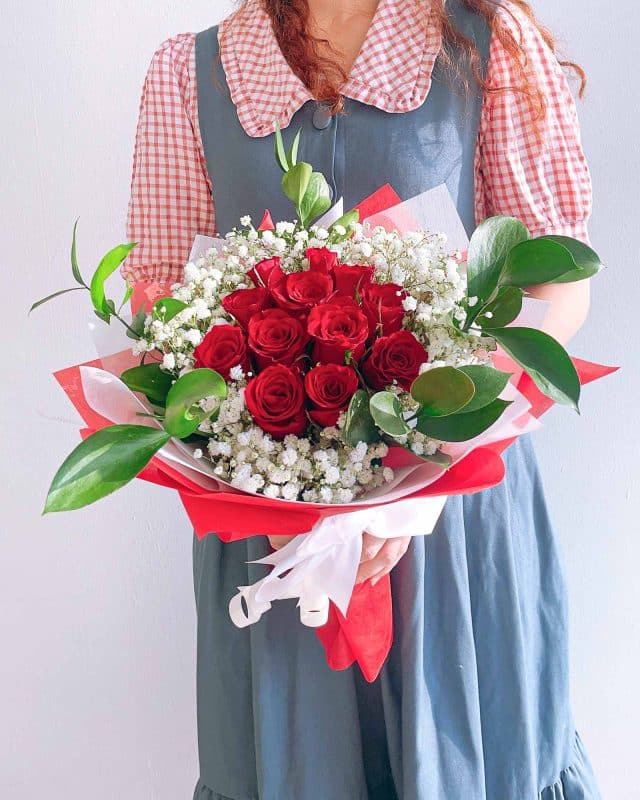 A bouquet of red roses and baby’s breath from Singapore florist Flowers and Kisses 