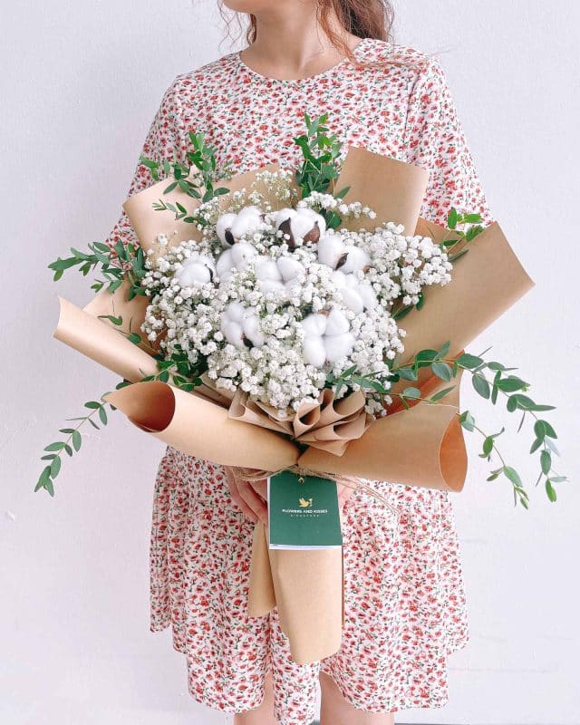 Flowers and kisses cloud nine flower arrangement using white baby’s breath and cotton puffs to evoke a snowy forest