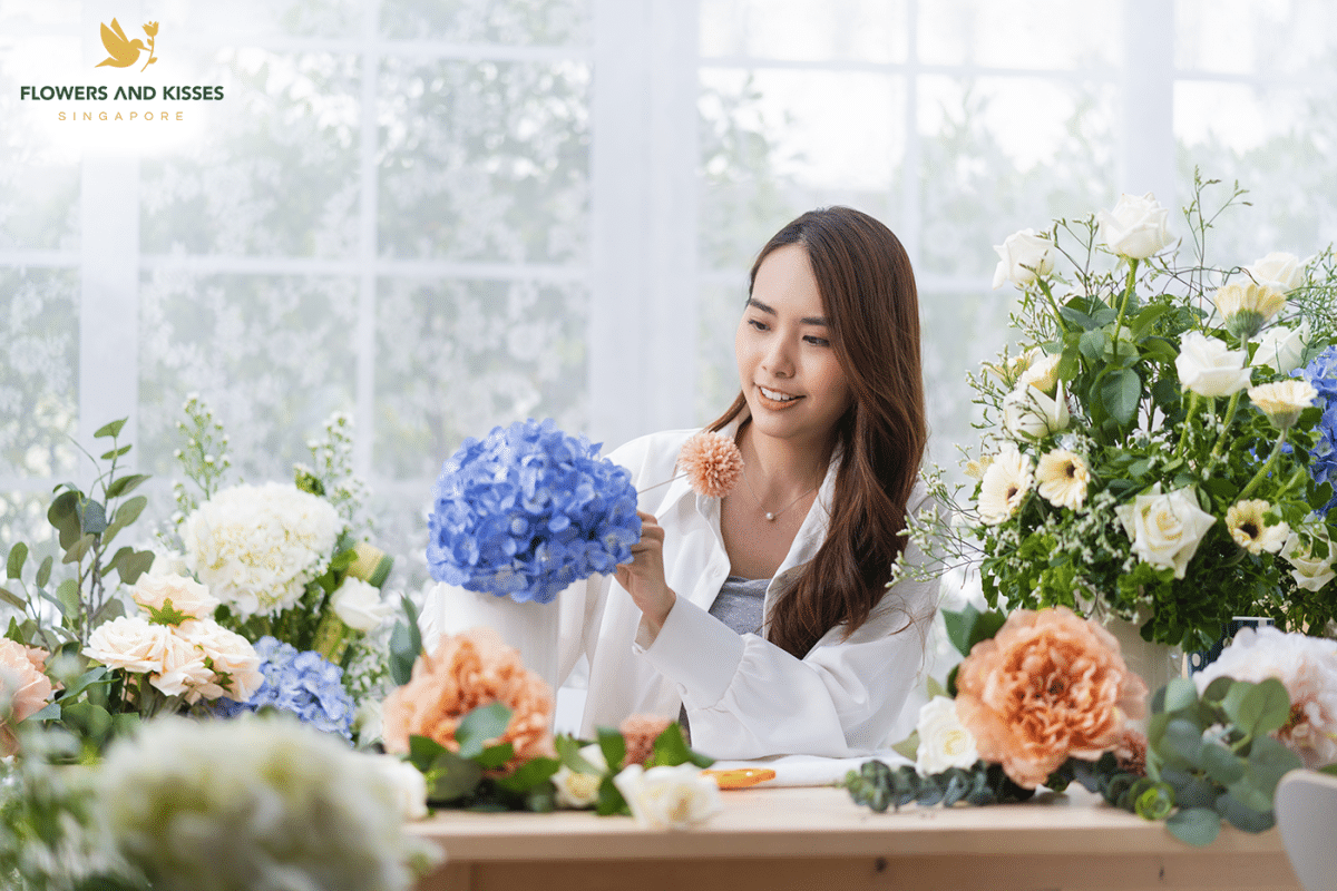 A guide to flower delivery in Singapore Singaporean online florist prepares an order of flowers from a client