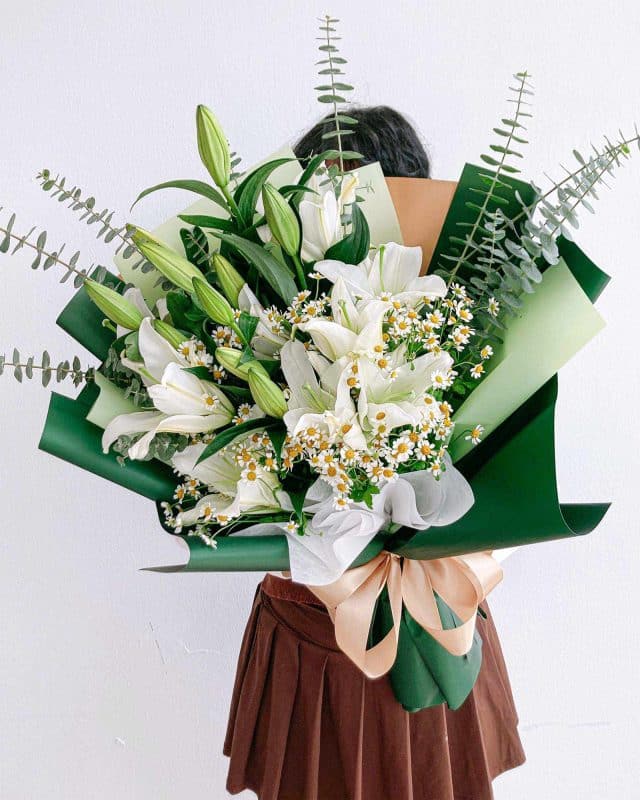 A bouquet of white lilies, daisies and eucalyptus from Singapore florist Flowers and Kisses 